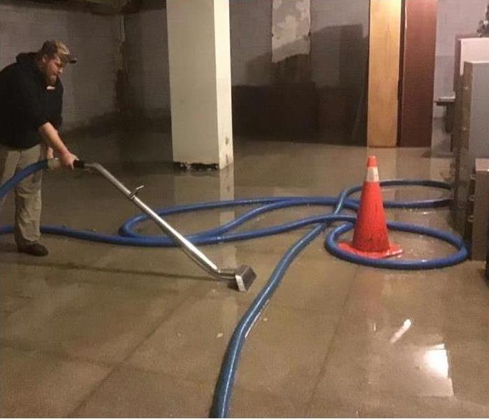 technician extracting water from floor in Toledo