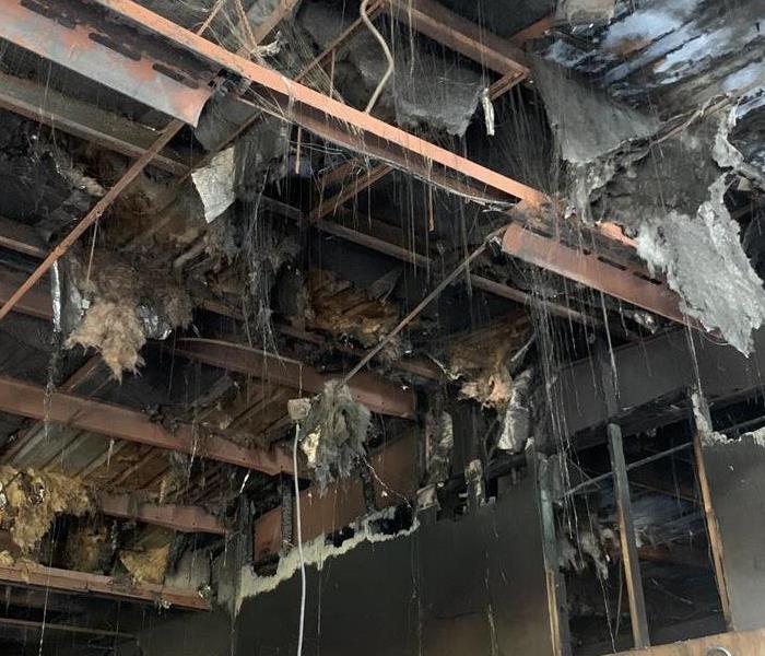 Burnt out ceiling of a maintenance building with "spiderwebbing" hanging down